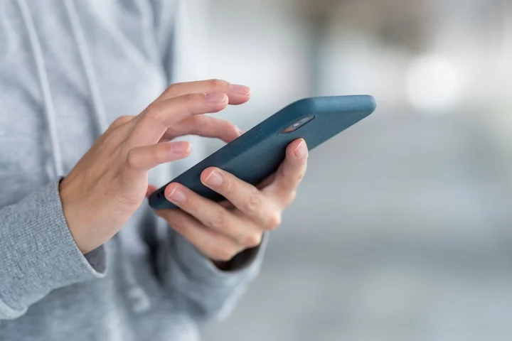 A person swiping the screen of the smartphone