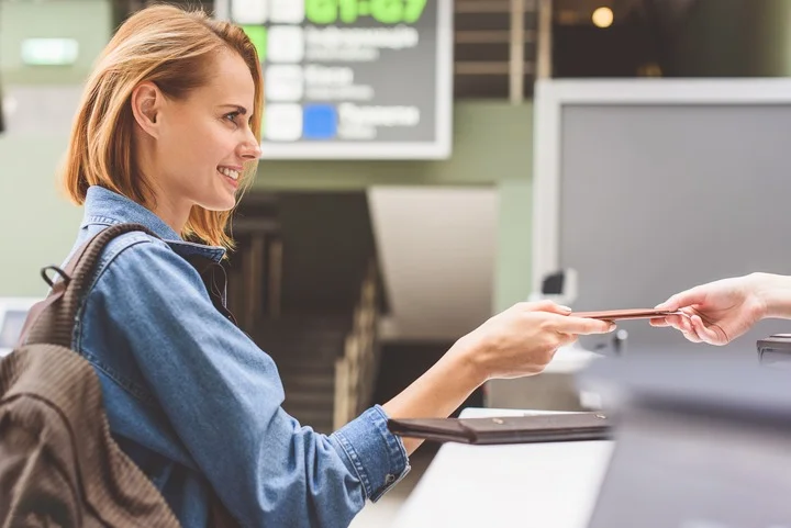 Person giving their documents to the customs person