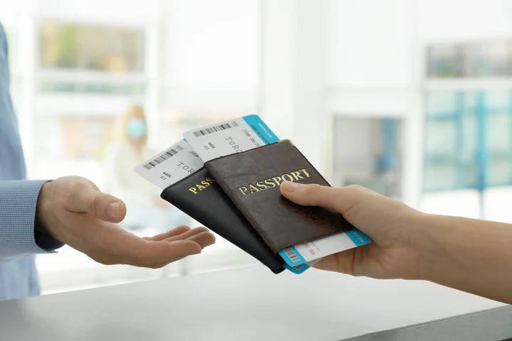 Person handing their passports to other person